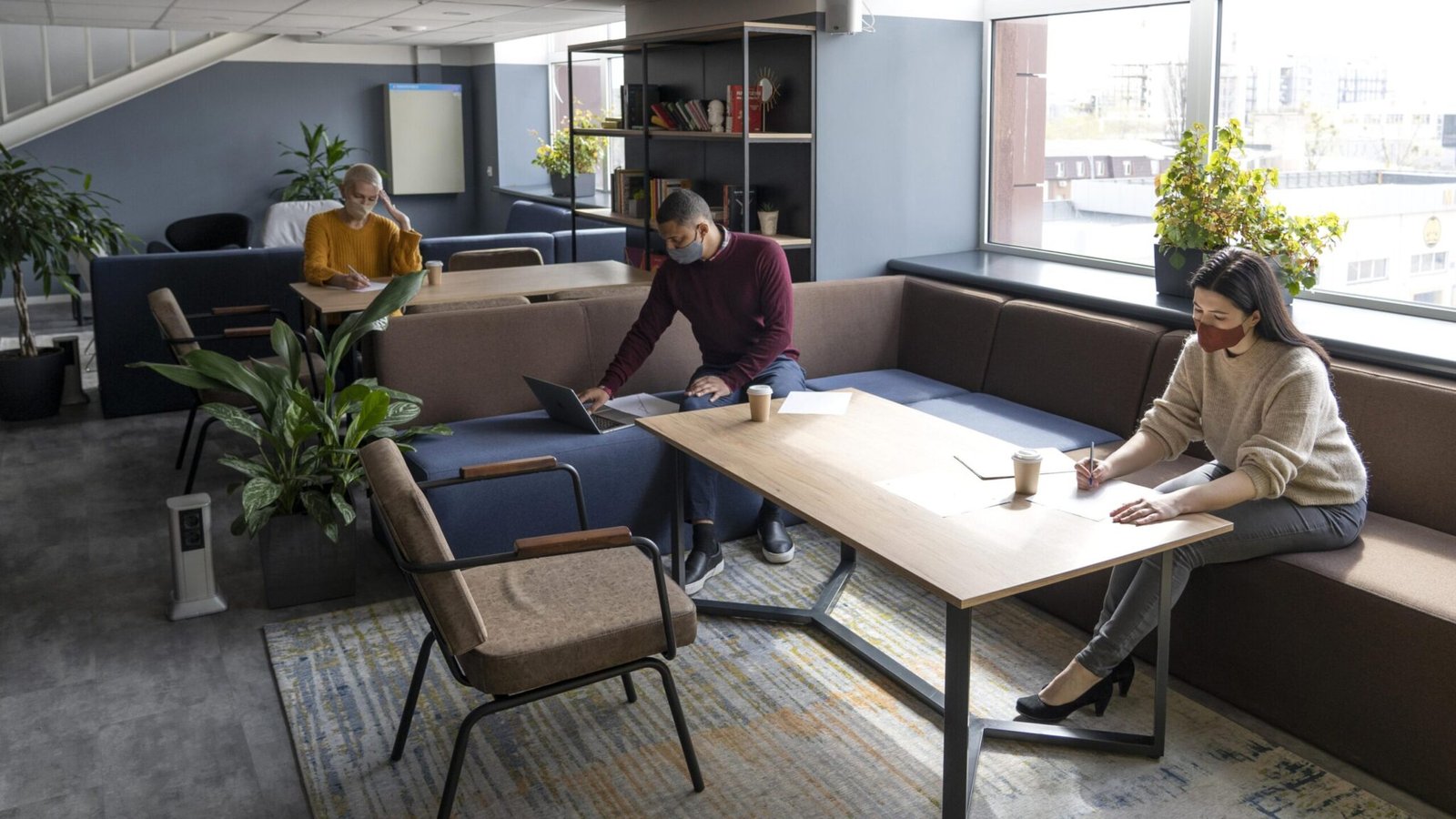 team collaborating in an office with smart furniture 2048x1152